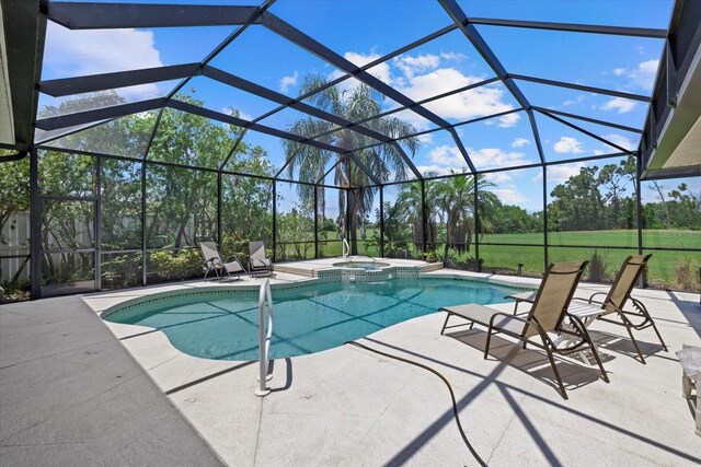 view of swimming pool featuring a pool with connected hot tub, a patio, and glass enclosure