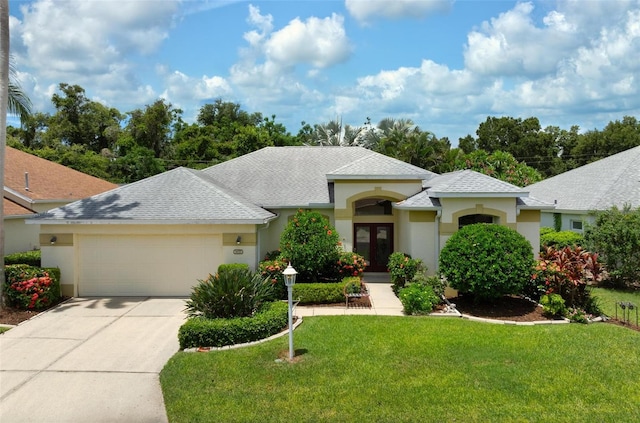 view of front facade with a garage and a front lawn