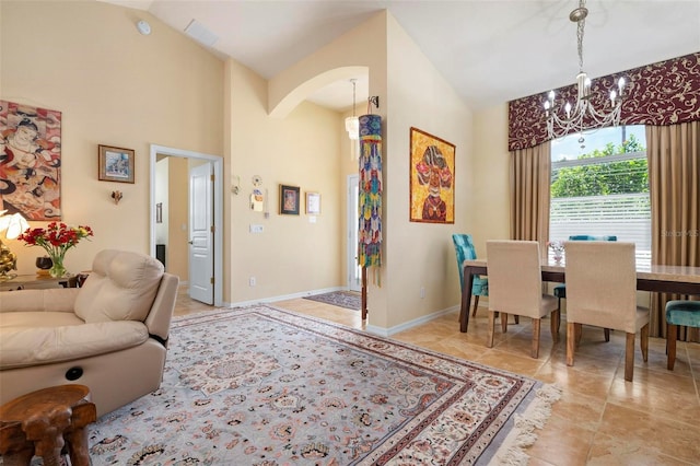 dining area with high vaulted ceiling and a chandelier