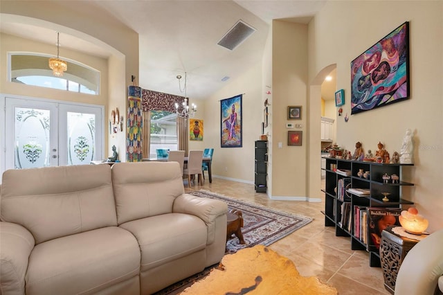 living room with french doors, light tile patterned flooring, high vaulted ceiling, and a notable chandelier