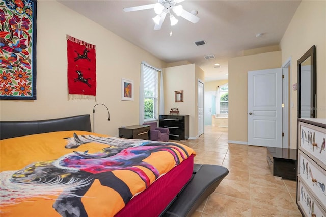 bedroom with light tile patterned floors, ceiling fan, and ensuite bathroom