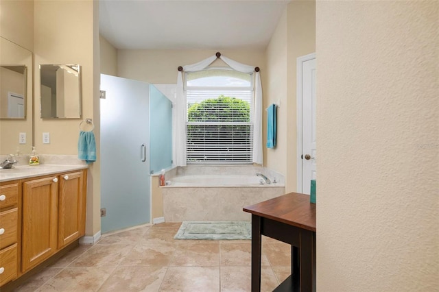 bathroom with vanity and independent shower and bath