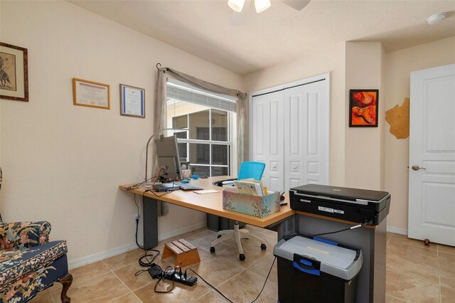 tiled home office featuring ceiling fan