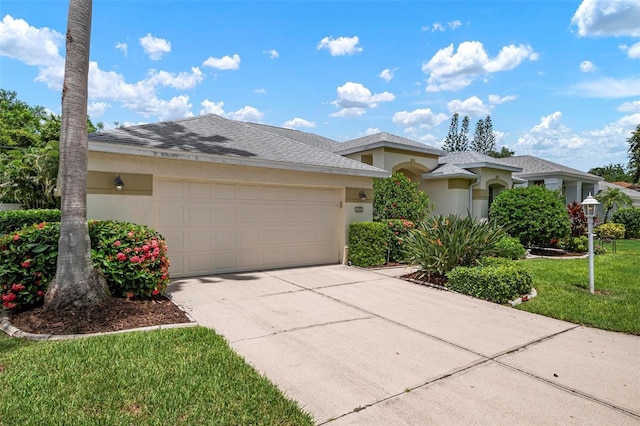 view of front of property featuring a garage and a front lawn