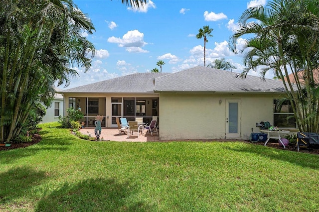 rear view of property featuring a patio and a lawn