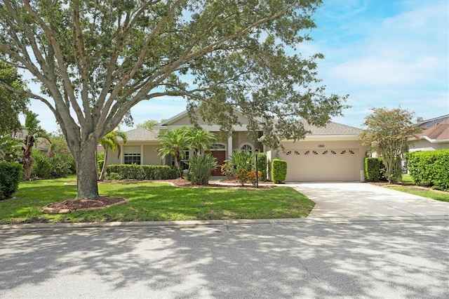 view of front of property with a front yard and a garage