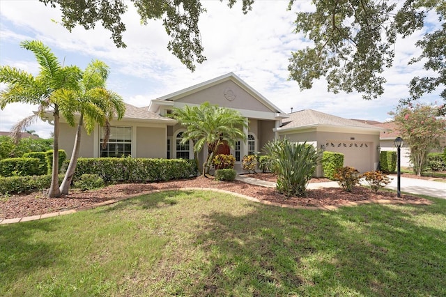 view of front of property with a front yard and a garage