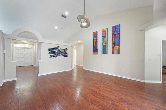 unfurnished living room with dark hardwood / wood-style flooring and high vaulted ceiling