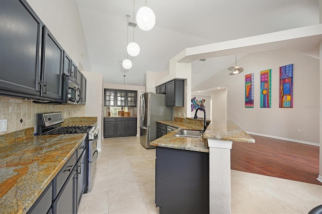 kitchen featuring sink, stainless steel appliances, light stone counters, pendant lighting, and light tile patterned floors