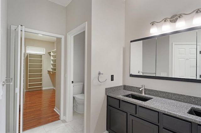 bathroom featuring tile patterned floors, vanity, and toilet