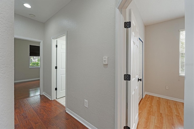 corridor with light hardwood / wood-style flooring