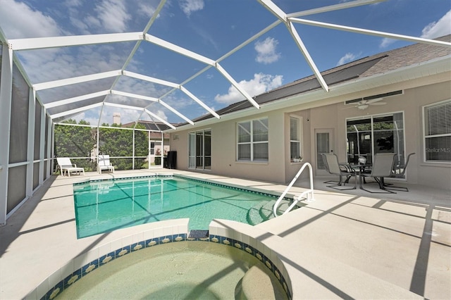 view of pool featuring a lanai, ceiling fan, a patio, and an in ground hot tub