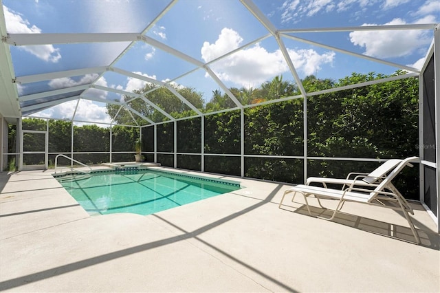 view of swimming pool featuring a patio and glass enclosure