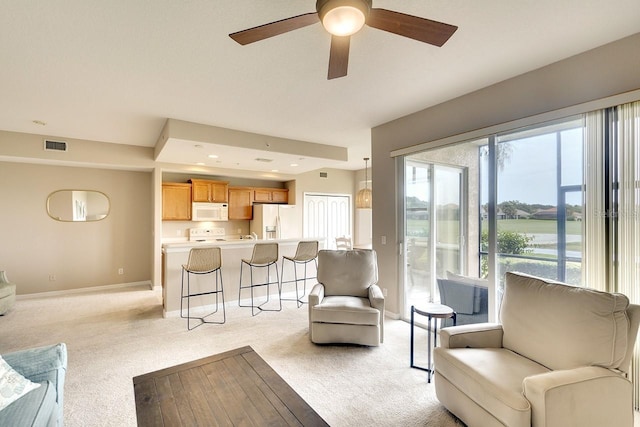 living room with light carpet and ceiling fan