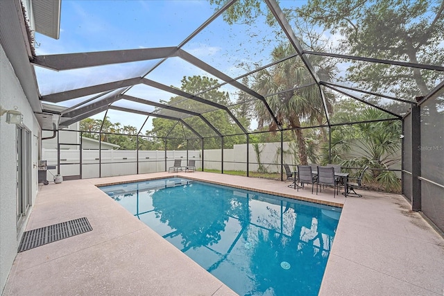 view of pool featuring a patio area and glass enclosure