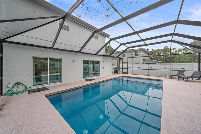 view of pool featuring a patio area and glass enclosure