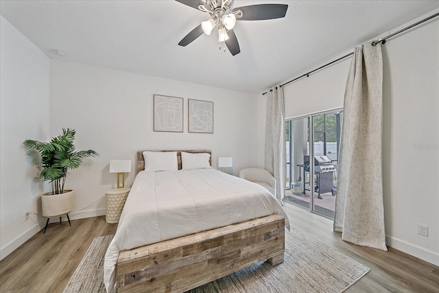 bedroom featuring wood-type flooring, access to outside, and ceiling fan