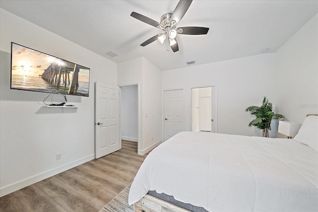 bedroom featuring light hardwood / wood-style floors and ceiling fan