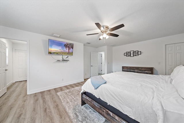 bedroom featuring light hardwood / wood-style flooring, a closet, and ceiling fan