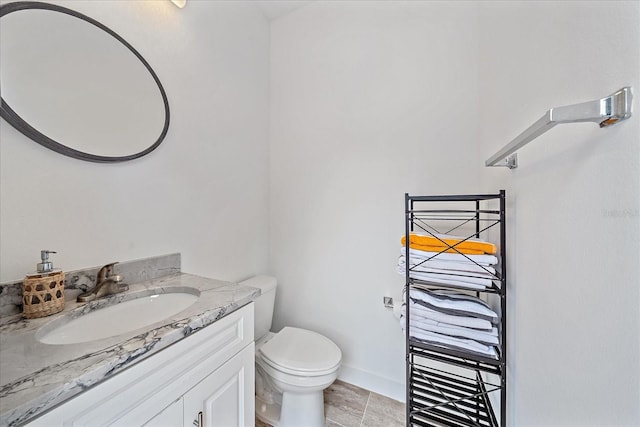 bathroom with vanity, toilet, and tile patterned flooring