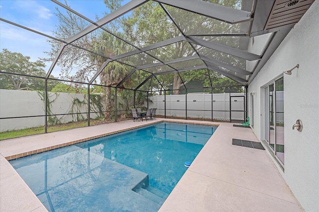 view of swimming pool with a patio area and a lanai