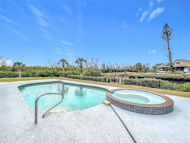 view of pool with an in ground hot tub