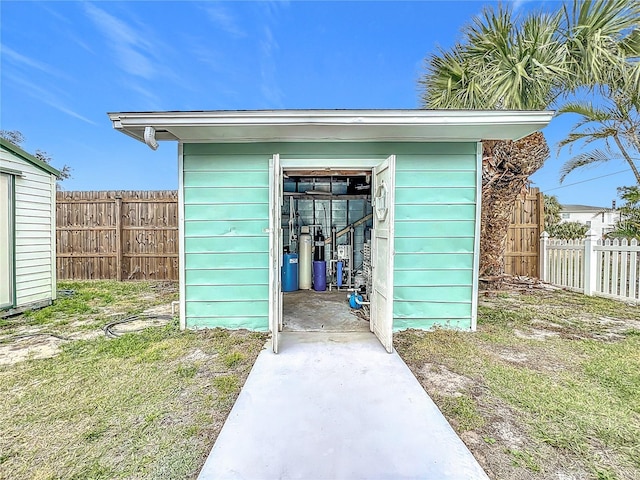 view of outbuilding featuring a lawn