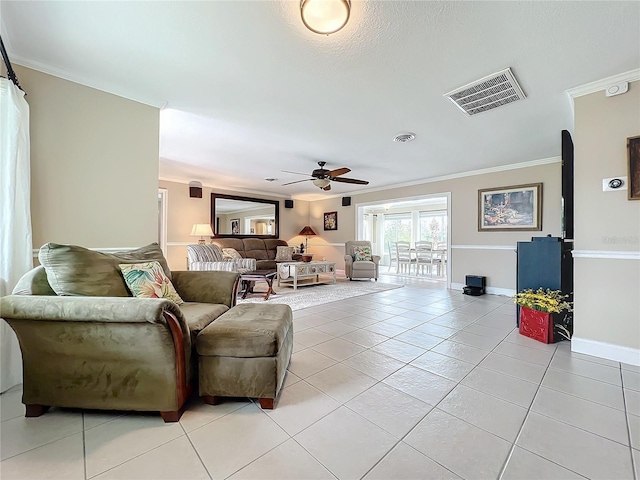 living room featuring ceiling fan, ornamental molding, and light tile patterned flooring