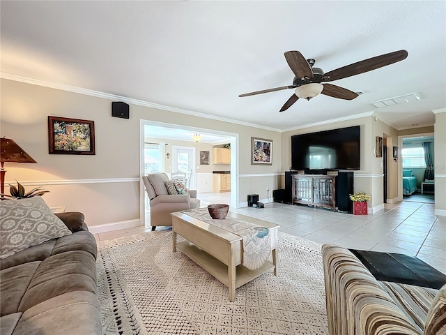 tiled living room with ceiling fan and crown molding