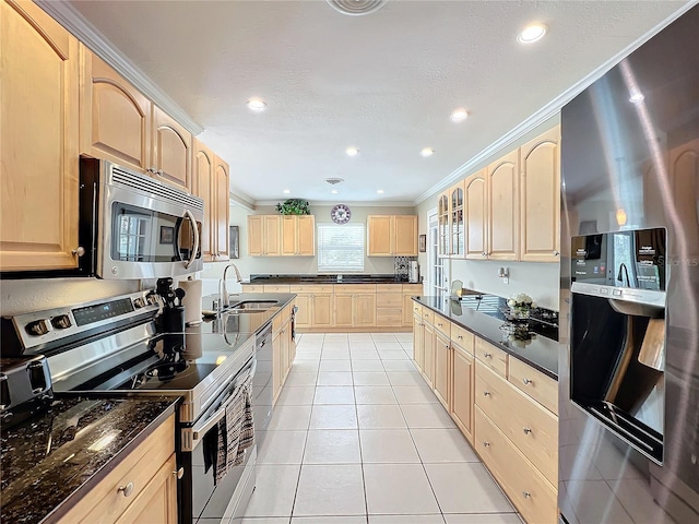 kitchen featuring sink, crown molding, light brown cabinets, stainless steel appliances, and light tile patterned floors