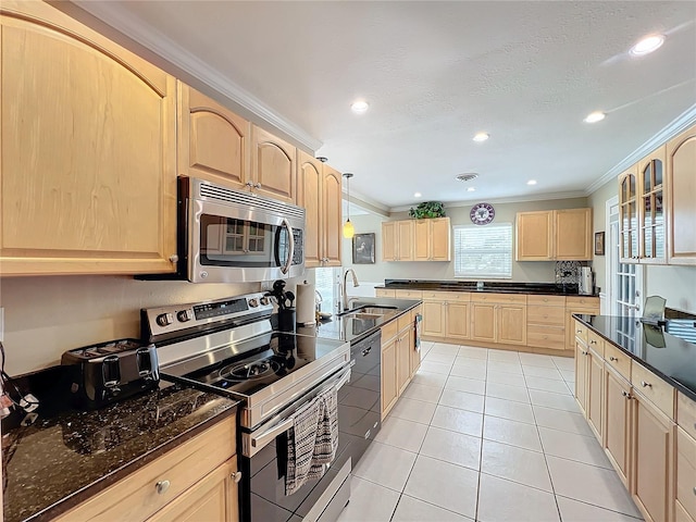 kitchen featuring light brown cabinets, ornamental molding, stainless steel appliances, and hanging light fixtures