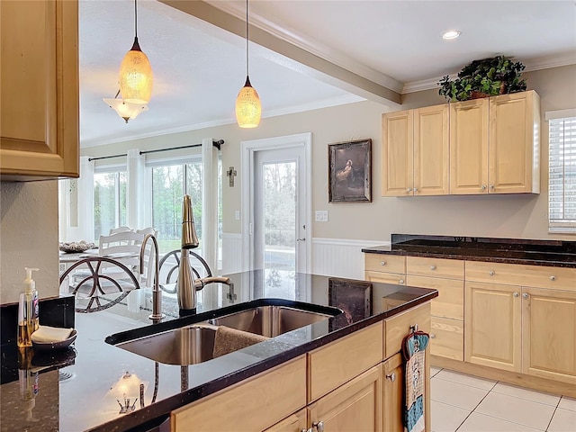 kitchen with sink, light brown cabinets, ornamental molding, and pendant lighting