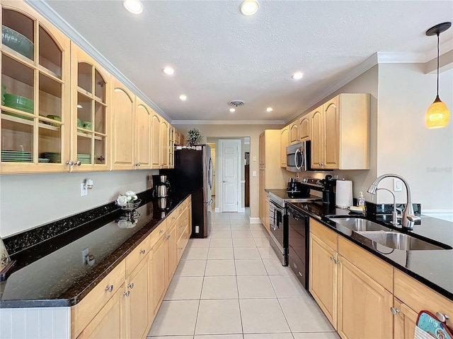 kitchen with decorative light fixtures, light tile patterned floors, sink, and stainless steel appliances