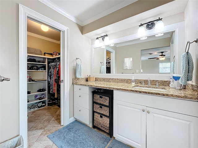 bathroom featuring ceiling fan, vanity, and crown molding