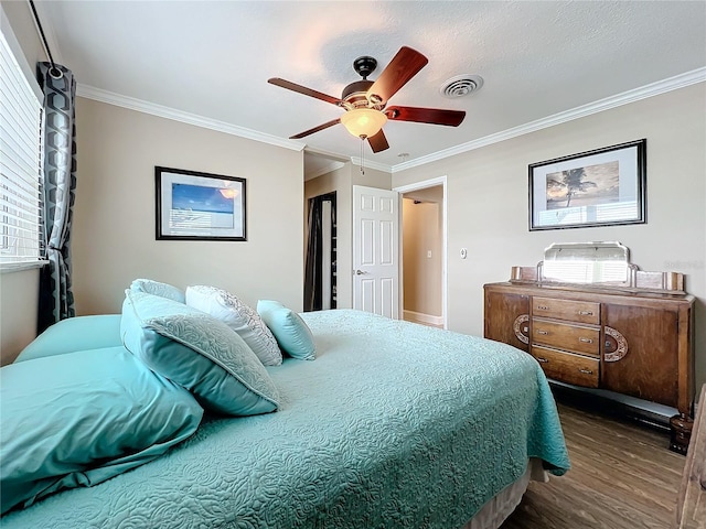 bedroom featuring ceiling fan, ornamental molding, and dark hardwood / wood-style floors