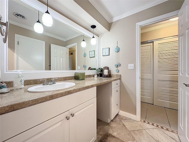 bathroom with tile patterned floors, vanity, and crown molding