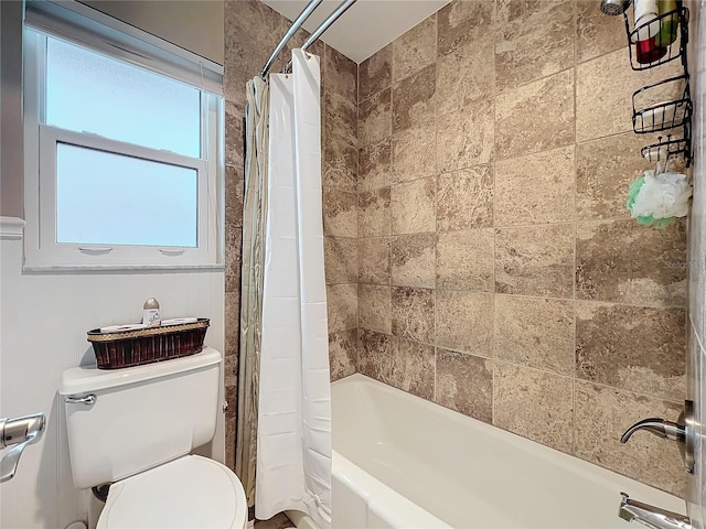 bathroom with toilet and shower / bath combo with shower curtain