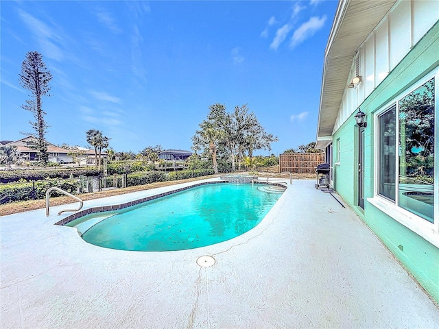 view of swimming pool featuring grilling area and a patio