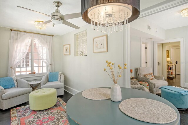 interior space with ceiling fan with notable chandelier and dark wood-type flooring