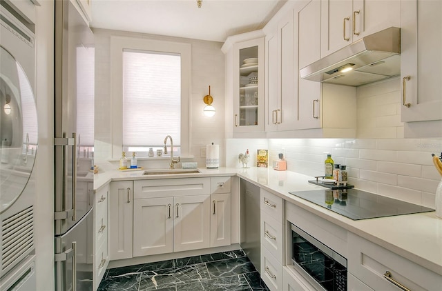 kitchen featuring white cabinetry, sink, backsplash, and black electric cooktop