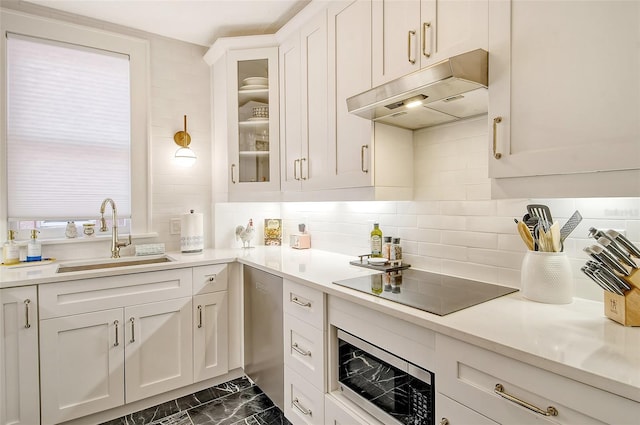 kitchen featuring white cabinetry, appliances with stainless steel finishes, sink, and backsplash