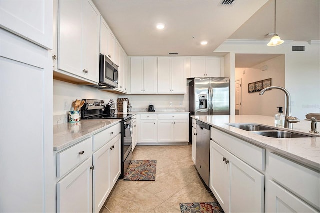 kitchen with white cabinetry, stainless steel appliances, hanging light fixtures, light stone counters, and sink