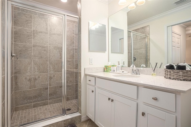 bathroom featuring crown molding, tile patterned floors, vanity, and a shower with shower door