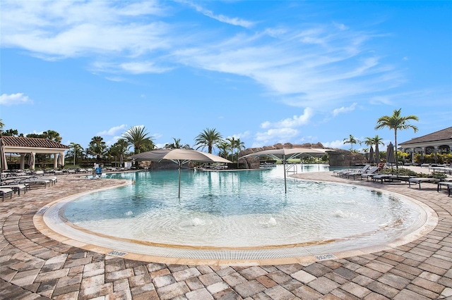 view of pool featuring pool water feature and a patio area