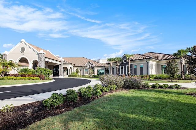 mediterranean / spanish house featuring a front lawn