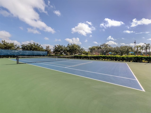 view of tennis court featuring fence