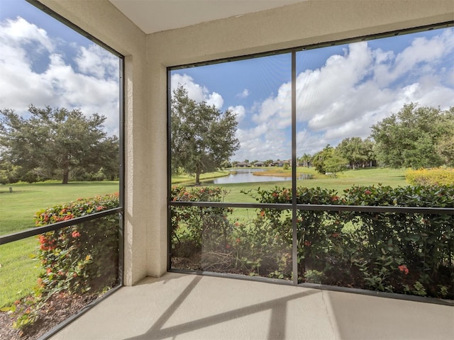 unfurnished sunroom featuring plenty of natural light and a water view