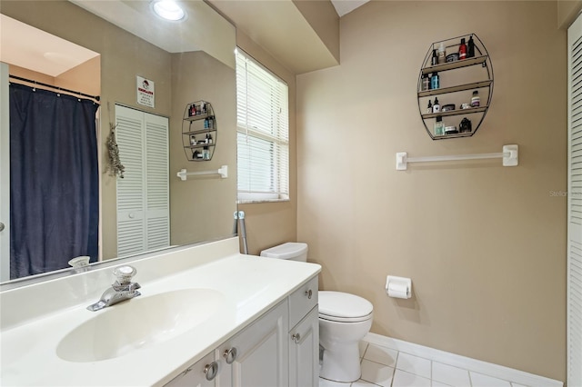 bathroom featuring vanity, tile patterned floors, and toilet