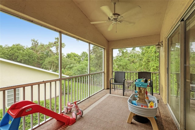 sunroom / solarium featuring ceiling fan and vaulted ceiling