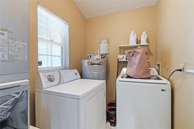 laundry room with washer and clothes dryer, electric water heater, and a textured ceiling